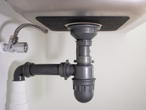 image of piping under a sink