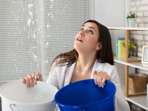 Lady catching leaking water