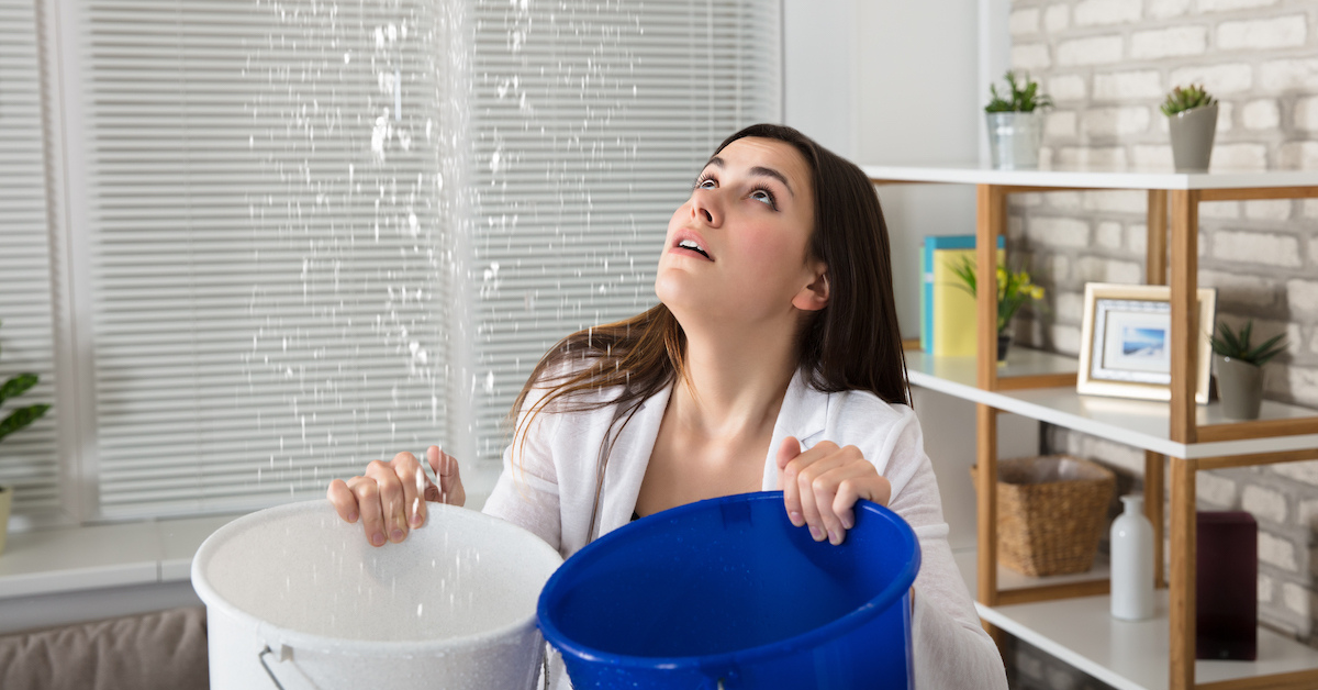 Lady catching leaking water